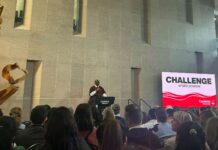New Carleton president Wisdom Tettey promises to ‘listen’ to community A man speaks at a podium in front of a crowd.