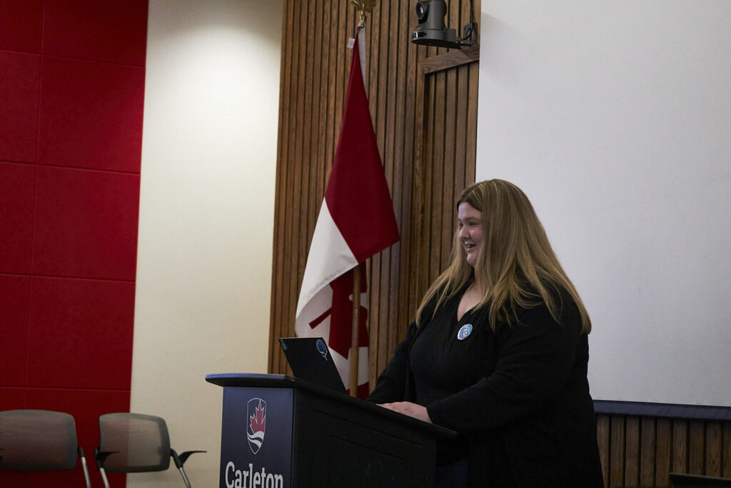 A person stands at a podium, giving a speech.