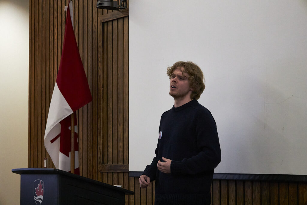 A man stands at a podium, giving a speech. 