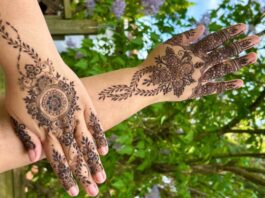 Hands with henna art on it.