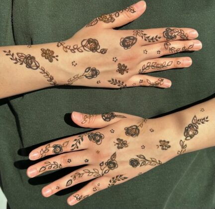 Hands with henna art on it.