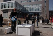 Experimental architecture studio reimagines emergency temporary shelters Man pours water on a white structure outside