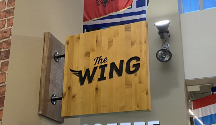 Wooden sign reading The Wing.