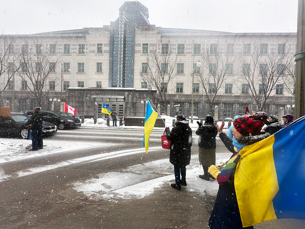 Protesters in downtown Ottawa carry Ukrainian flags to show their support for Ukraine in winter months.