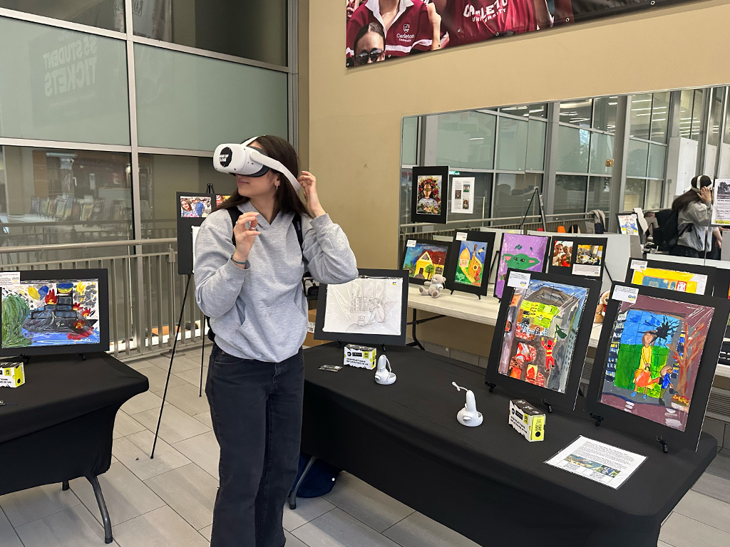 A student in front of an art display tries on a virtual reality headset at an event to support Ukraine in a university.