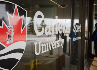 Here’s what Carleton students need to know about tuition increases and university funding changes Carleton University logo pasted on the glass wall of a campus building.