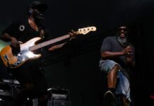 Review: The Roots rock Ottawa Jazz Festival stage with rhythm and groove Two men stand on stage, one has a bass guitar and the other grins.