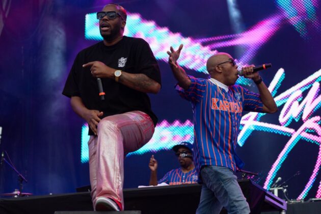 Two rappers jam out on stage.