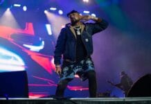 Bluesfest Day 6 review: Sean Paul and Peach Pit play to overcast atmosphere, varied crowd energy A man sings on a stage, and listens to the crowd singing back.