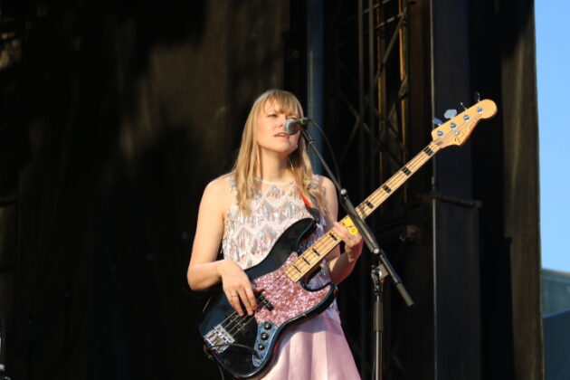a bass player plays on stage.