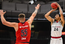 Ottawa BlackJacks acquired by Diamond Sports Canada Inc. BlackJacks player holds basketball over head to shoot over opponent.