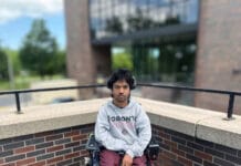 ‘Every university should have this’: Advocates, students praise Carleton’s new Coordinated Accessibility Strategy A person in a wheelchair wearing a gray sweater stares into the camera.
