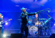 CityFolk Day 3 Review: Morrissey headlines a night of folk roots with Britpop A band performs on stage under a blue spotlight.
