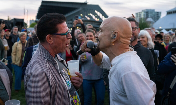 A singer sings with a fan.