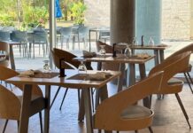 Upscale sit-down restaurant opens in Richcraft Hall Chairs and tables set up in a restaurant.