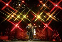 CityFolk Day 2 Review: Melissa Etheridge and Indigo Girls rock night of nostalgia A performer sings on stage under red and yellow lighting.