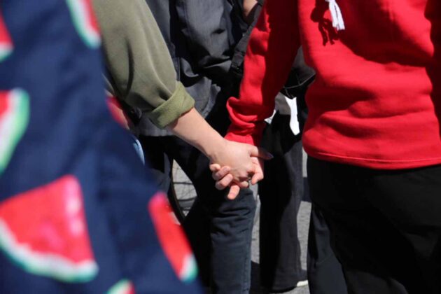 two people hold hands