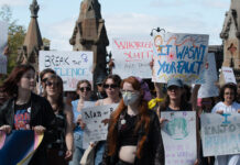 In photos: Ottawa SlutWalk ‘lights the fire’ against rape culture A crowd of people hold several signs as they march on the street. One sign says "I enjoy human rights." Another says "it wasn't your fault."