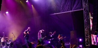 Here’s what you need to know ahead of CityFolk 2026 A band performs on stage under purple lighting.