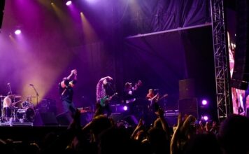 Here’s what you need to know ahead of CityFolk 2026 A band performs on stage under purple lighting.