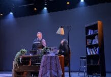 ‘Living with Drones’ brings audiences inside devastating stories from Gaza Two performers look up on a stage.