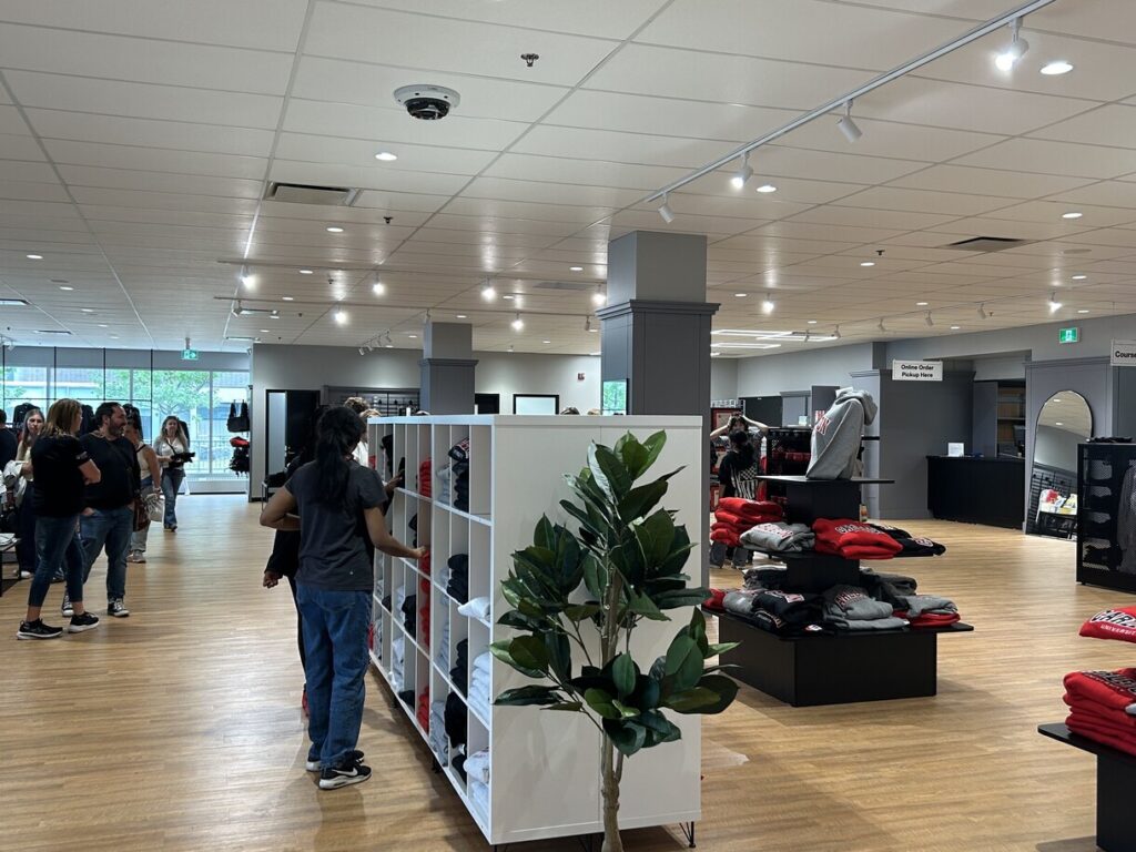 Clothes sit on shelves in a shop. 