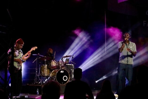 A band performs on stage at night.
