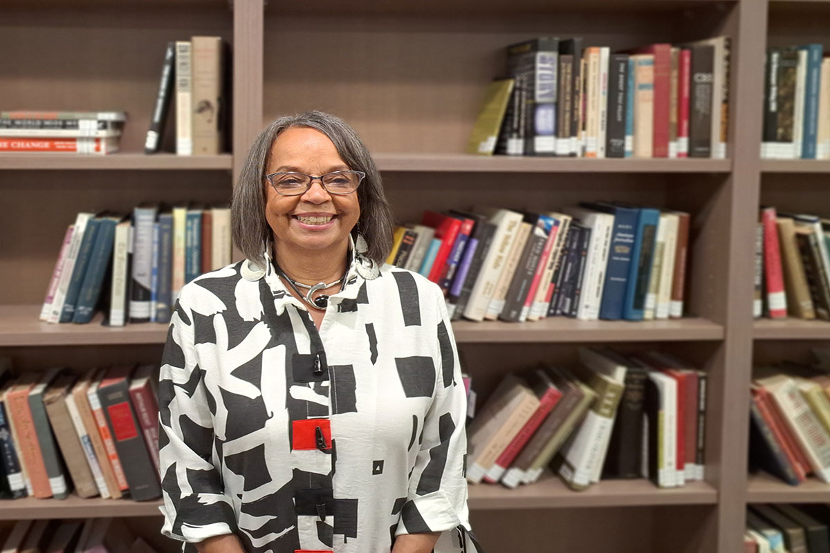 a woman stands in front of books