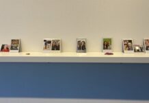 Gallery 101’s ‘Tânte Ohci’ uses bones and Polaroids to explore ancestry and land Polaroid photos of people are on display on a white shelf.