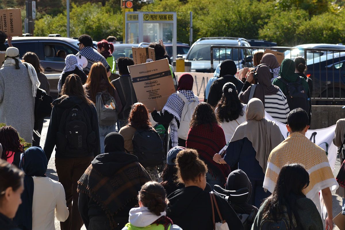 a crowd holds signs