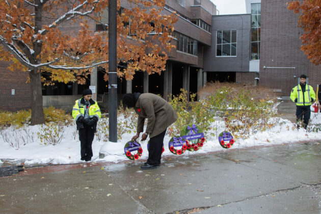 Man lays wreath