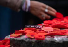 In Photos: Ottawa remembers in national ceremony downtown Lest We Forget written on a bracelet