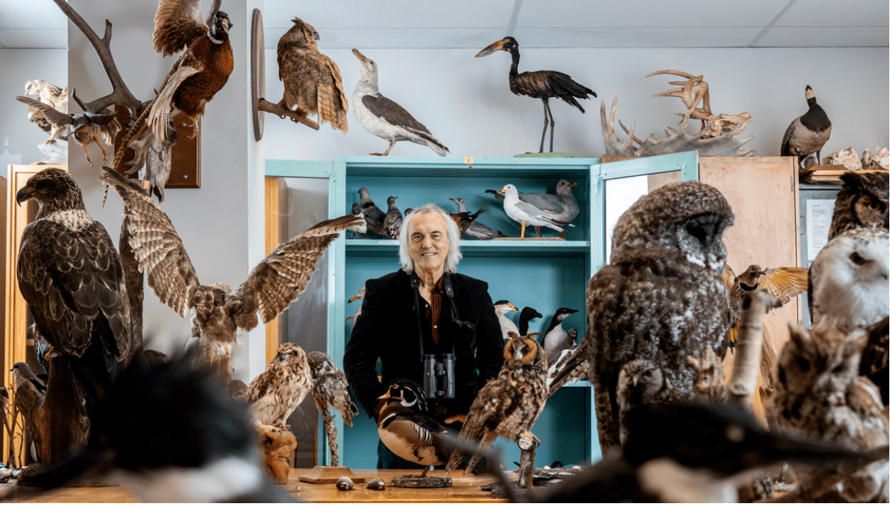 Michael Runtz stands among bird specimens he would use while teaching. Runtz began teaching at Carleton in 1992.