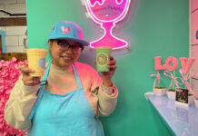 ‘Even across oceans’: Ottawa’s Filipino community stands together after twin typhoons A woman wearing an apron stands and holds two cups with liquids in them in front of a light-up decoration of a cup that says "Sweet Puspin Dessert Bar"