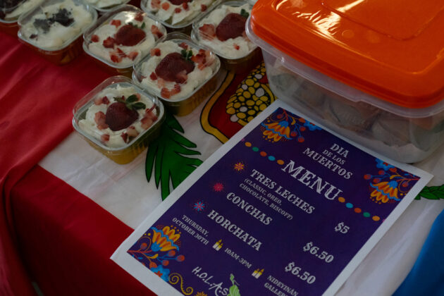 A purple paper that says "Dia De Los Muertos Menu"