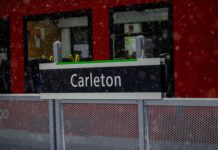 In photos: A winter wonderland at Carleton University Carleton written on O-Train sign banner during a snow storm.
