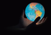 Editorial: Carleton’s global strategy is starting to deliver A man holding a world globe in his hands