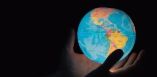 Editorial: Carleton’s global strategy is starting to deliver A man holding a world globe in his hands