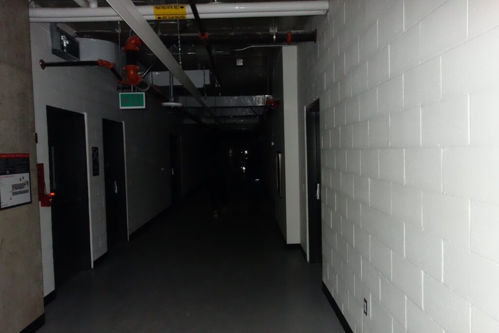 A campus tunnel in darkness.