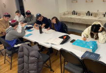 ‘On edge’: University of Ottawa community uneasy amid antisemitism incidents About a half dozen young adults sit at a table that has several books open on it and with some students writing in notebooks.