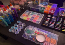 Glitter, beads and buttons: Here’s what goes into making craft night accessible Glitter glue, glitter and beads and buttons in a variety of shapes, sizes and colours sit on a table in a low-lit room
