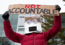 In photos: CUPE 4600 members rally against AI to ‘keep Carleton human’ Person holding a sign over their head.