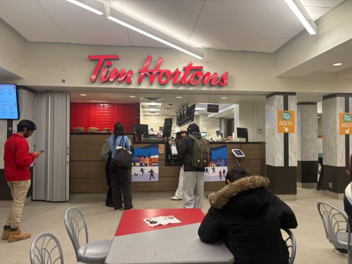 People standing in line at the Nideyinàn Tim Hortons.