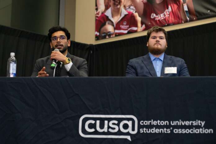 Two people at a desk.