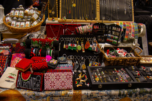 Handmade keychains, bracelets, necklaces and wallets cover a table