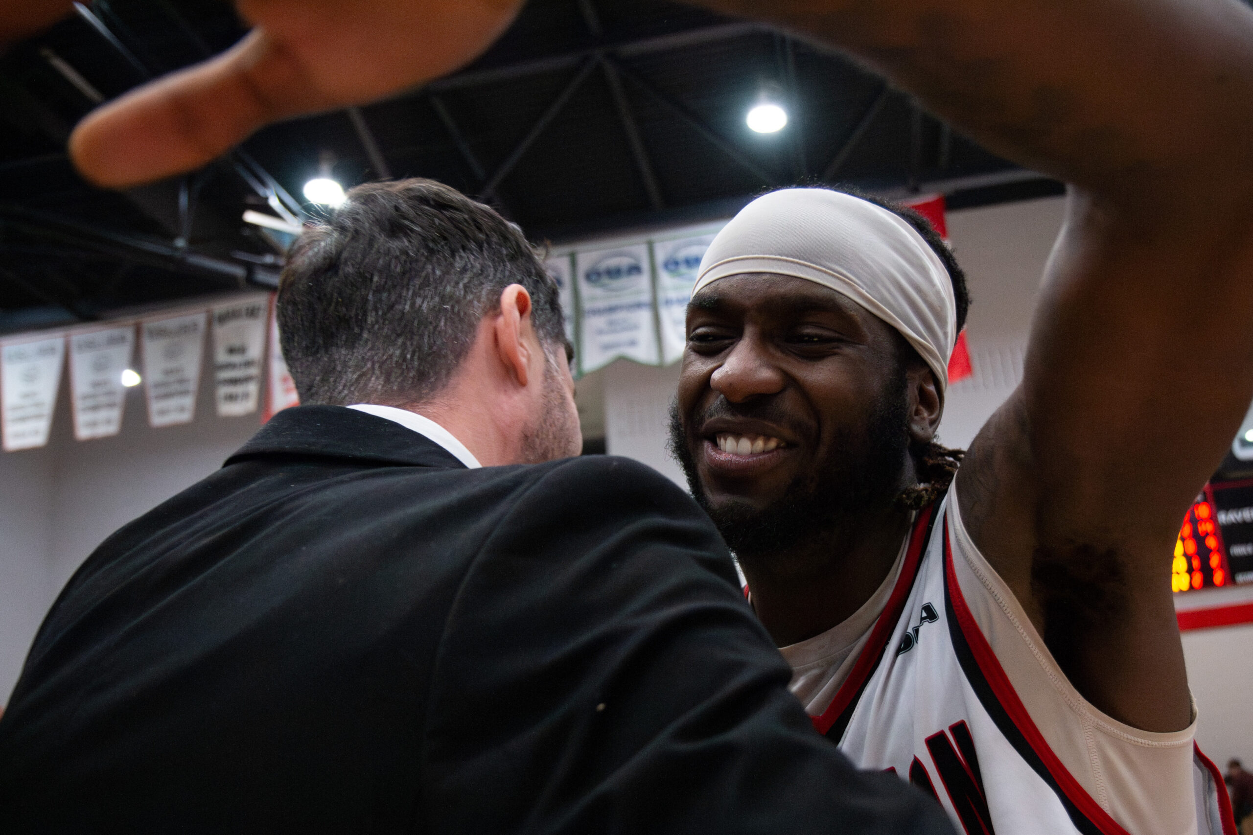 Basketball player hugs coach