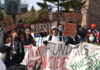 Campus protest calls on Board of Governors to divest from human rights violations A crowd of people holding signs with messages like "Stop funding genocide, divest now," "We CU investing in genocide," "divest from apartheid," and "You're on the wrong side of history"