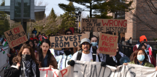 Campus protest calls on Board of Governors to divest from human rights violations A crowd of people holding signs with messages like "Stop funding genocide, divest now," "We CU investing in genocide," "divest from apartheid," and "You're on the wrong side of history"