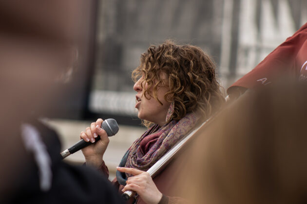 A person holds a microphone up to their mouth