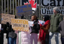 In photos: Walkout for OSAP slows traffic on Bronson Avenue People holding a sign and protesting OSAP changes